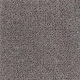 Dense gray fabric texture with short pile and granular weave, exhibiting matte finish and subtle tonal variations throughout the surface.
